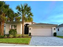 Two-story home with attached garage and landscaping at 5013 Sevilla Shores Dr, Wimauma, FL 33598