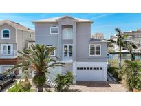 Charming two-story home showcasing architectural details and a well-maintained yard with mature palm trees at 13737 Victor Ave, Hudson, FL 34667