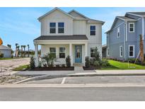 Charming two-story home boasts a welcoming porch and stylish blue front door at 196 Eagleston Ln, Lakewood Ranch, FL 34240