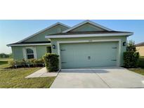 Charming single-story home with a well-maintained lawn and a two-car garage at 6698 Wirevine Dr, Brooksville, FL 34602