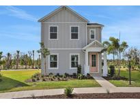 Charming two-story home featuring light grey siding and a welcoming pink front door at 200 Eagleston Ln, Lakewood Ranch, FL 34240