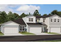 Charming townhome exterior with a two car garage and manicured landscaping at 7575 Sea Oak Ct, Parrish, FL 34219