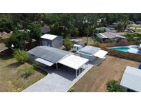 Expansive aerial view of home highlighting pool, carport, and additional storage outbuilding at 4125 Worcester Rd, Sarasota, FL 34231