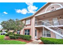 Charming condo with exterior staircase, tidy landscaping, and brick-accented facade at 4804 Myrtle Oak Dr # 11, New Port Richey, FL 34653