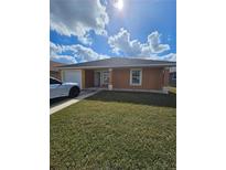 Charming single-story home with a well-maintained lawn and attached garage at 1544 Blue Bayou Cir, Ruskin, FL 33570