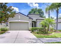 Charming single-story home boasts a well-manicured lawn and lush landscaping at 107 Dakota Hill Dr, Seffner, FL 33584