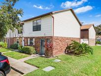 Charming townhome with brick accents, well-maintained landscaping, and a cozy front yard at 3401 Sunrise Villas S Ct, Tampa, FL 33614