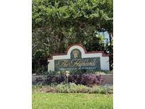 A welcoming entrance sign for The Highlands Condominium Residences amidst lush greenery at 9481 Highland Oak Dr # 715, Tampa, FL 33647