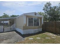 Cozy home with a covered entrance and a charming exterior design on a sunny day at 9202 Teak St, New Port Richey, FL 34654