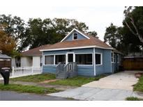 Charming blue single-story home with a welcoming front porch and well-maintained lawn at 5117 16Th Ave, Gulfport, FL 33707