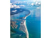 Stunning aerial view of the coastline featuring beautiful turquoise waters and luxury residences at 891 Island Way, Clearwater Beach, FL 33767