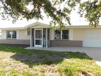 Charming single-story home with well-maintained lawn and inviting entryway with security doors at 3536 Harbor Blvd, Port Charlotte, FL 33952