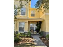 Inviting front exterior of a two-story townhome with a small porch and landscaping at 3433 Dragon View Ct, Valrico, FL 33594
