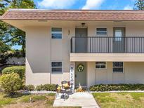 Charming condo featuring an inviting entrance with a 'Welcome' sign and cozy seating area at 9945 47Th N Ave # 110, St Petersburg, FL 33708