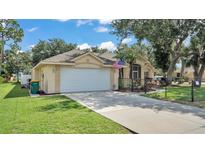 Charming single-story home featuring a well-manicured lawn and a two-car garage at 23338 Duchess Ave, Port Charlotte, FL 33954