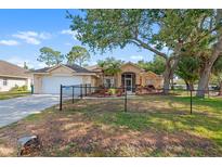 Charming single-story home with well-maintained lawn and mature trees, offering great curb appeal at 23338 Duchess Ave, Port Charlotte, FL 33954