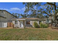 Tan house with a spacious lawn and mature trees at 4317 S Trask St, Tampa, FL 33611