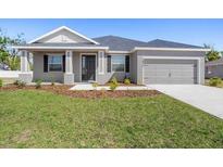 Charming single-story home featuring a well-manicured lawn and attached two-car garage at 2634 58Th E Cir, Palmetto, FL 34221