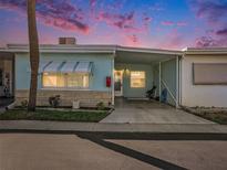 Charming single-story home with a covered parking area under a colorful sky at 250 Rosery Nw Rd # 260, Largo, FL 33770
