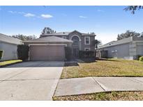 Charming two-story home with a well-manicured lawn and a two-car garage at 19245 Wood Sage Dr, Tampa, FL 33647