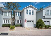Charming two-story home with a gray exterior, brick driveway, and an attached garage, perfect for comfortable living at 2311 W Morrison Ave # 13, Tampa, FL 33629