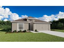 Inviting single-story home boasts a well-manicured lawn, neutral tones, and an attached two-car garage at 6080 Ballast Dr, Wimauma, FL 33598