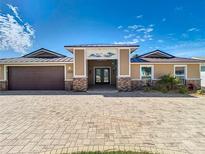 Charming single-story home featuring a paved driveway and a welcoming entryway with decorative accents at 5509 Pilots Pl, New Port Richey, FL 34652