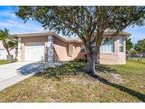 Charming single-Gathering home with a well-maintained lawn, mature landscaping, and an attached one-car garage at 1112 21St E St, Palmetto, FL 34221
