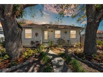 Inviting single-story home with mature trees and landscaped front yard at 923 26Th N St, St Petersburg, FL 33713