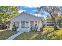 Charming single-story home featuring a welcoming front porch with classic white pillars at 3105 N 17Th St, Tampa, FL 33605