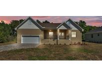 Charming single-Gathering home with a two-car garage and manicured lawn at 12500 Green Oak Ln, Dade City, FL 33525