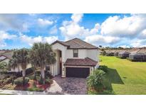 Stunning two-story home featuring a tile roof, two-car garage, and beautifully landscaped front yard at 6914 Quiet Creek Dr, Bradenton, FL 34212