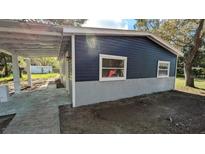Charming home featuring durable siding, a covered carport, and a freshly painted exterior at 37906 Tucker Rd, Zephyrhills, FL 33542
