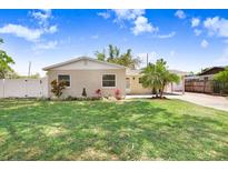 Charming single-story home featuring a well-manicured lawn and a welcoming brick facade at 1411 Fernwood Pl, Seffner, FL 33584