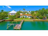 Waterfront property with a private dock and lush landscaping, perfect for enjoying coastal living at 1140 Boca Ciega Isle Dr, St Pete Beach, FL 33706