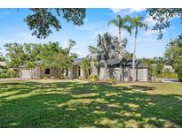 Inviting single-story home with lush lawn, mature trees, and neatly manicured landscaping at 7313 Crape Myrtle Way, Sarasota, FL 34241