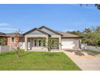 Charming single-story home featuring well-manicured lawn and attached two car garage at 5227 Lime Ave, Seffner, FL 33584
