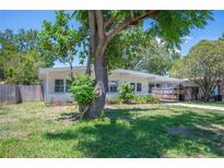 Charming single-story home with a well-maintained lawn and mature trees providing ample shade at 6011 67Th N Ave, Pinellas Park, FL 33781
