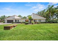 Charming single-story home with well-maintained landscaping and a lush green lawn at 107 Seville N Ct, Plant City, FL 33566
