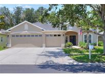 Charming single-story home features a 3-car garage, well-maintained landscaping, and a welcoming front entrance at 1233 Emerald Hill Way, Valrico, FL 33594