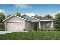 Charming single-story home with a two-car garage, well-manicured lawn, and beautiful landscaping at 6021 Mangrove Creek Rd, Wimauma, FL 33598