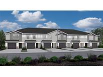 Attractive townhome exteriors boast a gray palette, private garages, and manicured landscaping at 2770 Walden Town Cir, Plant City, FL 33566