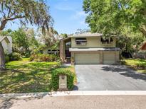 Charming two-story home with a spacious three-car garage and a well-maintained lawn at 2872 Hammock Dr, Plant City, FL 33566