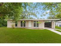 Charming single-story home with a well-maintained lawn and an attached carport at 1018 Briarwood Ave, Tampa, FL 33613