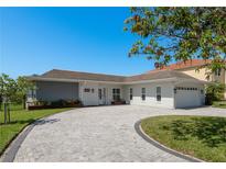 Charming single-story home featuring a brick driveway, attached garage, and manicured landscaping at 3626 Corsair Ct, New Port Richey, FL 34652