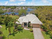 Stunning waterfront home with lush landscaping and a tile roof and beautiful water views at 5903 Cachette De Riviera Ct, New Port Richey, FL 34655