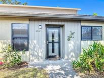 Charming front entrance with decorative lizard and updated windows, providing a welcoming curb appeal at 6012 28Th W St, Bradenton, FL 34207