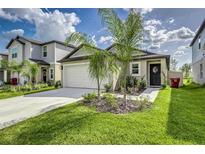 Charming single-Gathering home with a well-manicured lawn, two-car garage and beautiful landscaping at 4035 Radiant Mountain Dr, Plant City, FL 33565