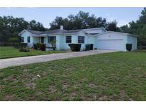 Charming single Gathering home with an attached garage and a well-maintained front yard at 1002 W La Salle St, Tampa, FL 33607