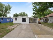 Charming single-story home featuring a carport and updated white exterior at 1317 E Laura St, Plant City, FL 33563